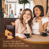 Two women enjoying Xemenry Organic Mushroom Coffee in a cafe setting, promoting health benefits and social moments.