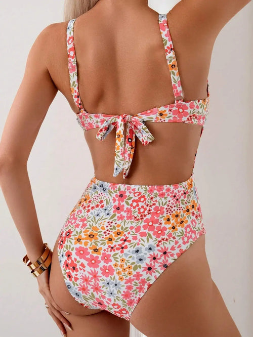 Sweet summer style in a floral print one-piece swimsuit. Embrace the sunshine and enjoy your vacation in this charming swimwear