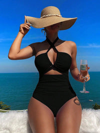 Crisscross halter one-piece swimsuit with wide-brimmed hat, showcasing elegant vacation style. Enjoy the sun, savor the sea view