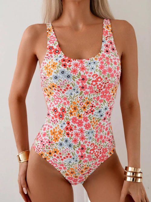 Sweet summer style in a floral print one-piece swimsuit. Embrace the sunshine and enjoy your vacation in this charming swimwear