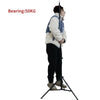 Person demonstrating the 2M tripod's stability and weight capacity of 50KG, ideal for photography and videography.