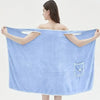Woman wearing a blue wearable bath towel showcasing its large size and convenient pocket for adults.