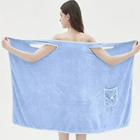Woman wearing a blue wearable bath towel showcasing its large size and convenient pocket for adults.