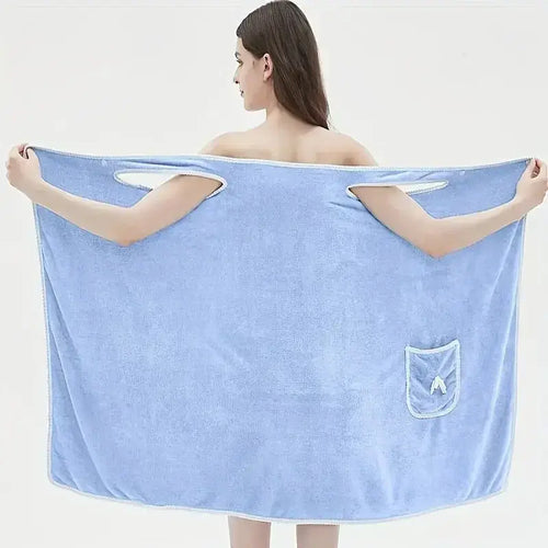 Woman wearing a blue wearable bath towel showcasing its large size and convenient pocket for adults.