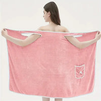 Woman wearing a coral velvet bath towel with bowknot design, showcasing water absorption and quick drying features.