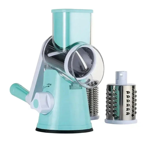 Manual rotary vegetable slicer with stainless steel drums for easy grating and chopping, in a light green color.